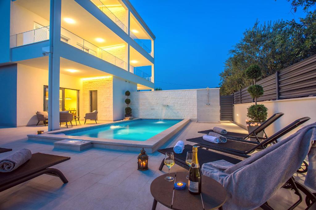 a swimming pool in the backyard of a house at Villa Filip in Kaštela