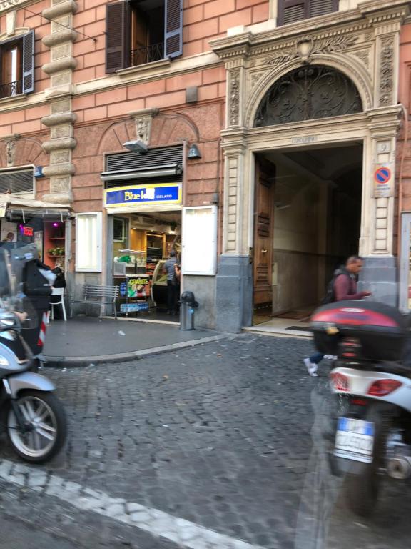 a motorcycle is parked on a street in front of a building at Ottaviano Lodge in Rome