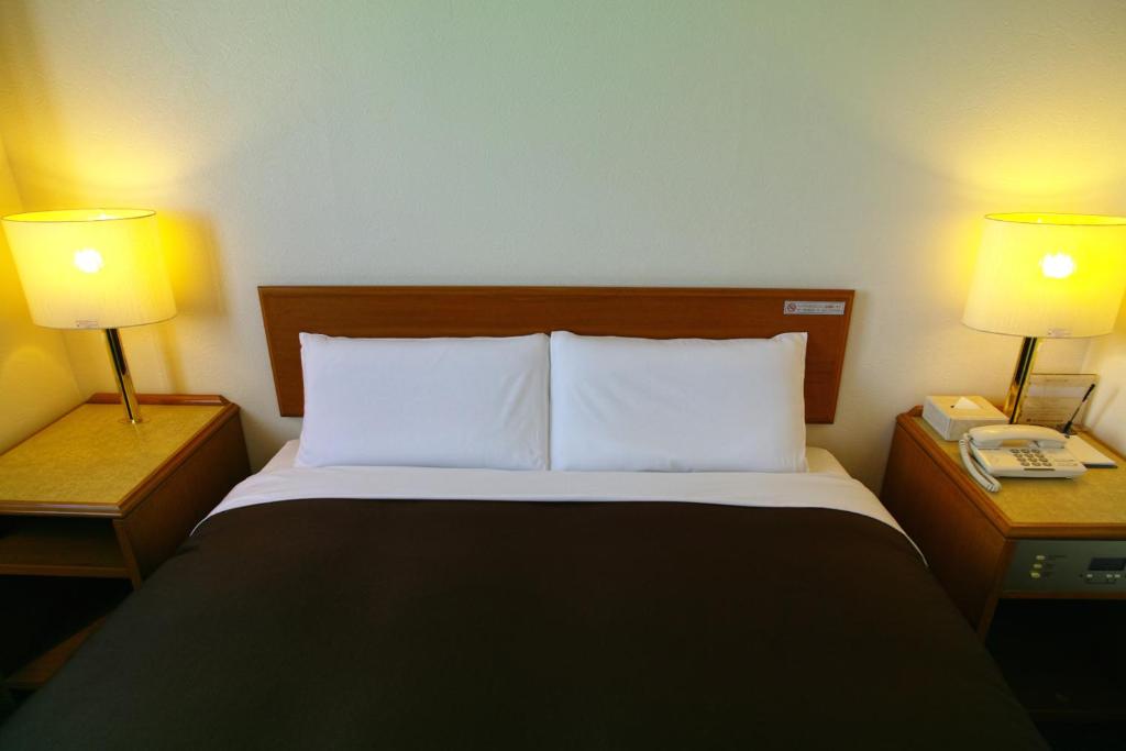 Postel nebo postele na pokoji v ubytování Tourist Hotel Hitachi