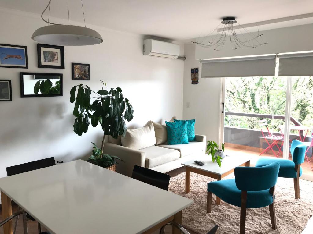 a living room filled with furniture and a window at Marín Apartments in Puerto Iguazú