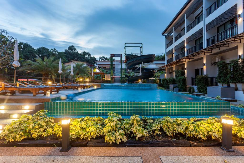 a swimming pool in a hotel at night at Aonang Viva Resort - SHA Plus in Ao Nang Beach