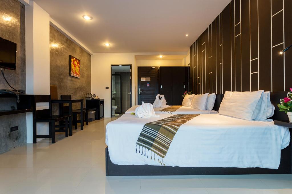 a hotel room with two beds and a kitchen at Aonang Viva Resort - SHA Plus in Ao Nang Beach