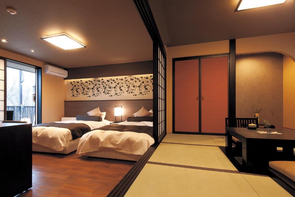 Postel nebo postele na pokoji v ubytování Hotel Morinokaze Tateyama‎