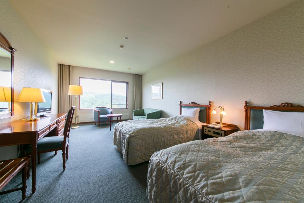 Postel nebo postele na pokoji v ubytování Sky Park Hotel