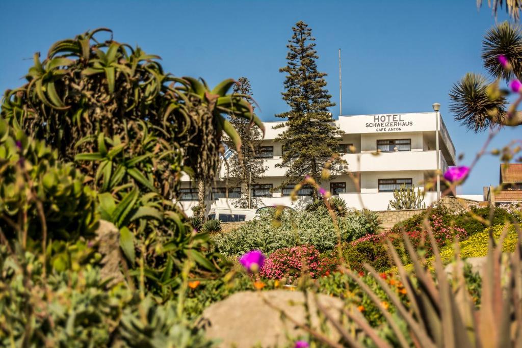 a building with a lot of plants in front of it at Hotel Schweizerhaus/Cafe Anton in Swakopmund