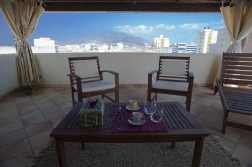 a living room with a table and chairs and a view at La Mattanza in Trapani