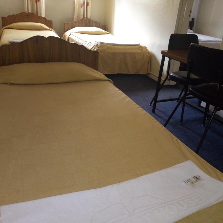 Postel nebo postele na pokoji v ubytování Adventist LMS Guest House & Conference Centre