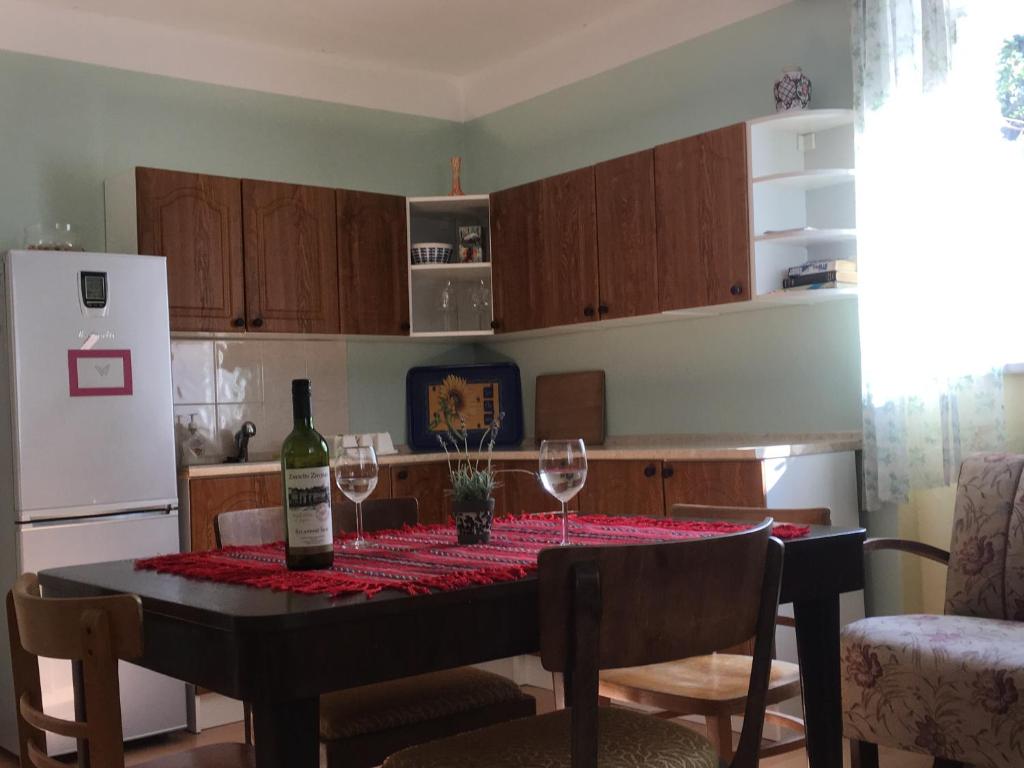 ズノイモにあるDOMOV-VINA Holiday Apartmentのキッチン(ワイングラス付きのテーブル付)