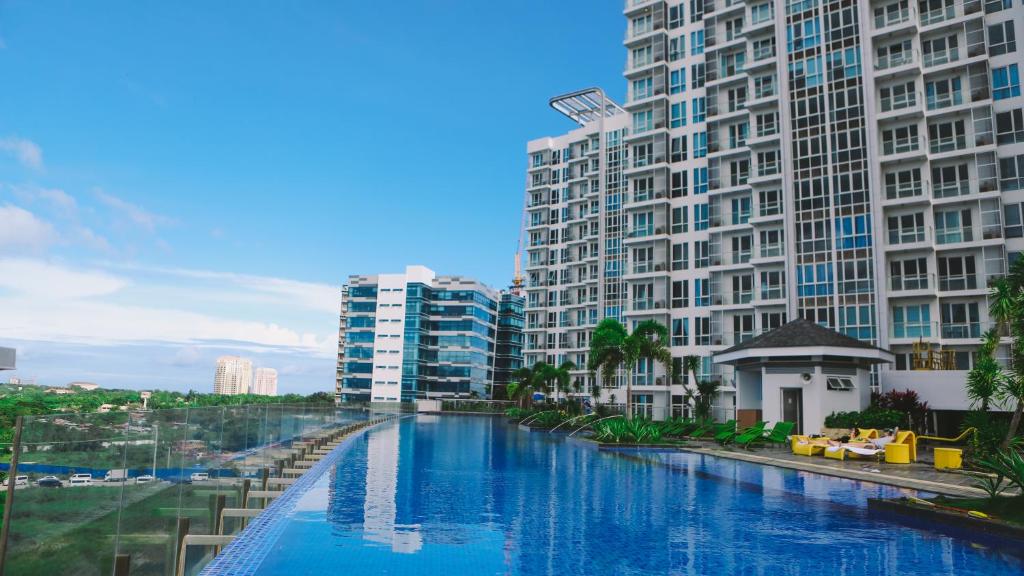 a river in the middle of a city with tall buildings at Mactan Newtown Beach Condo in Mactan