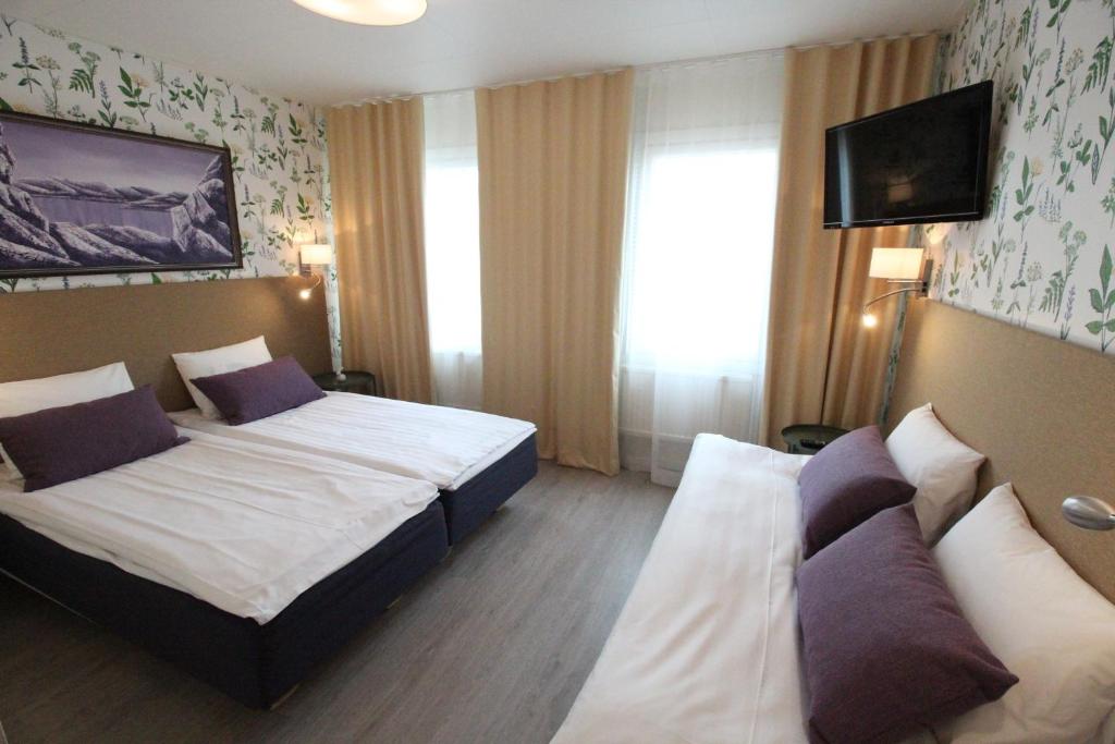 Postel nebo postele na pokoji v ubytování Hotel Aakenus
