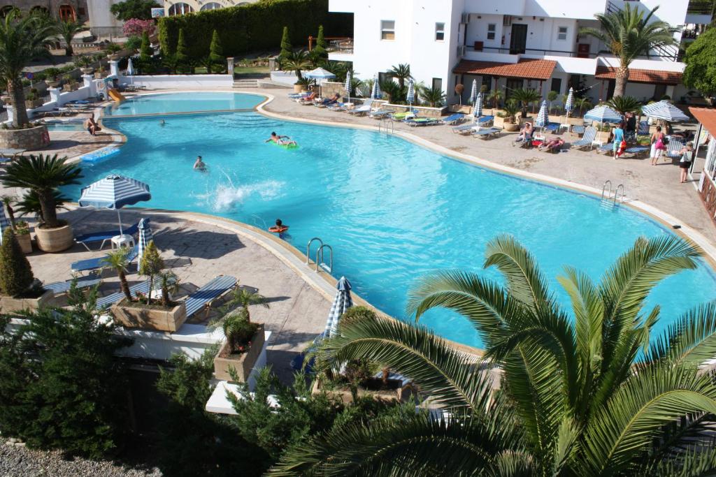 an overhead view of a swimming pool in a resort at Coliseum Studios & Apartments in Pefki Rhodes