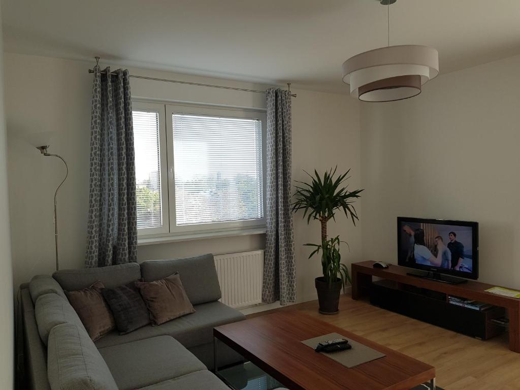 a living room with a couch and a table at Hennela Apartment in Warsaw