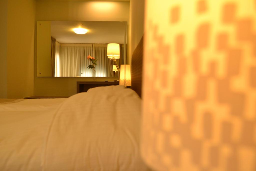 Postel nebo postele na pokoji v ubytování Ellopia Point Hotel