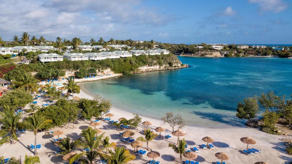 an aerial view of a beach with umbrellas and the ocean at The Verandah Antigua - All Inclusive - Adults Only in Willikies