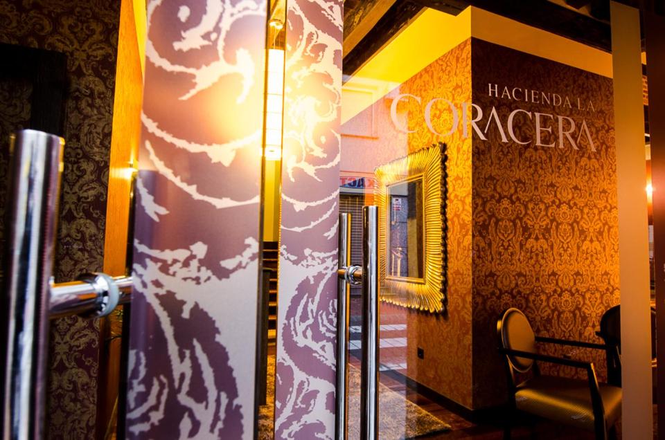 a hallway of a building with a sign on the wall at Hacienda la Coracera in San Martín de Valdeiglesias