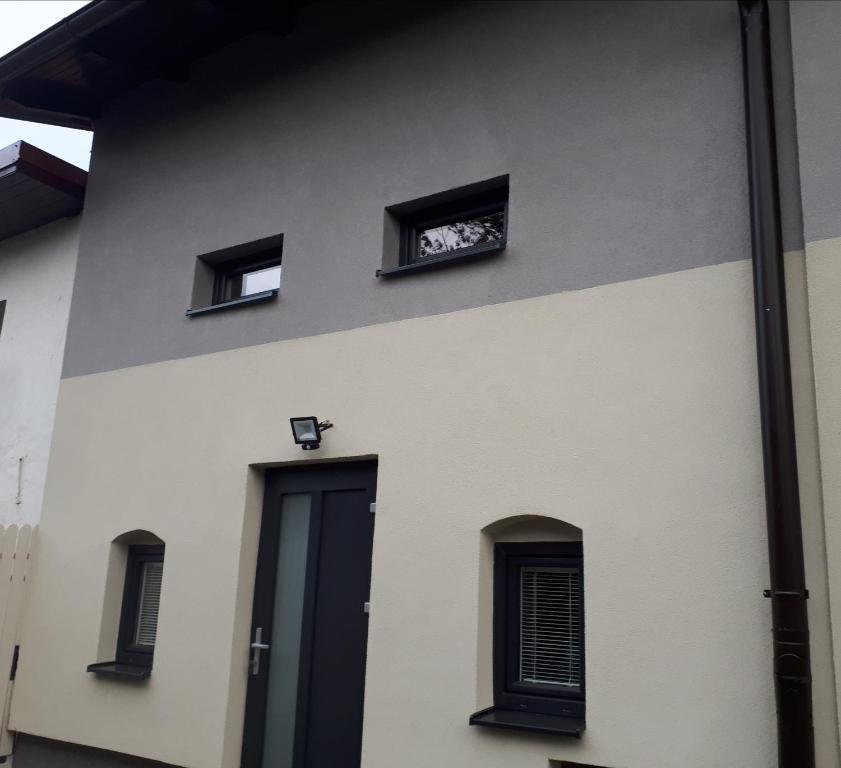 a building with three windows and a door at Apartament TA3 in Veľký Slavkov