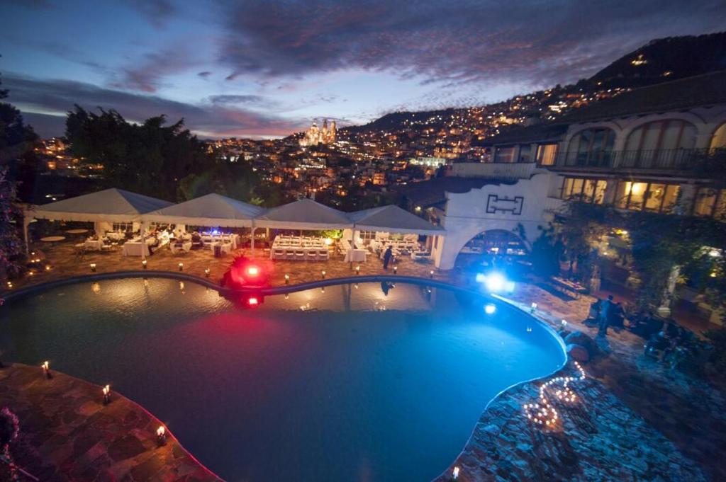 a view of a swimming pool at night at Posada de la Mision, Hotel Museo y Jardin in Taxco de Alarcón