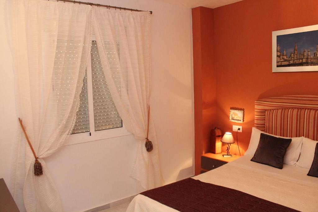 a bedroom with a bed and a window at Calle José Payán nº 28, 1º B in Camas