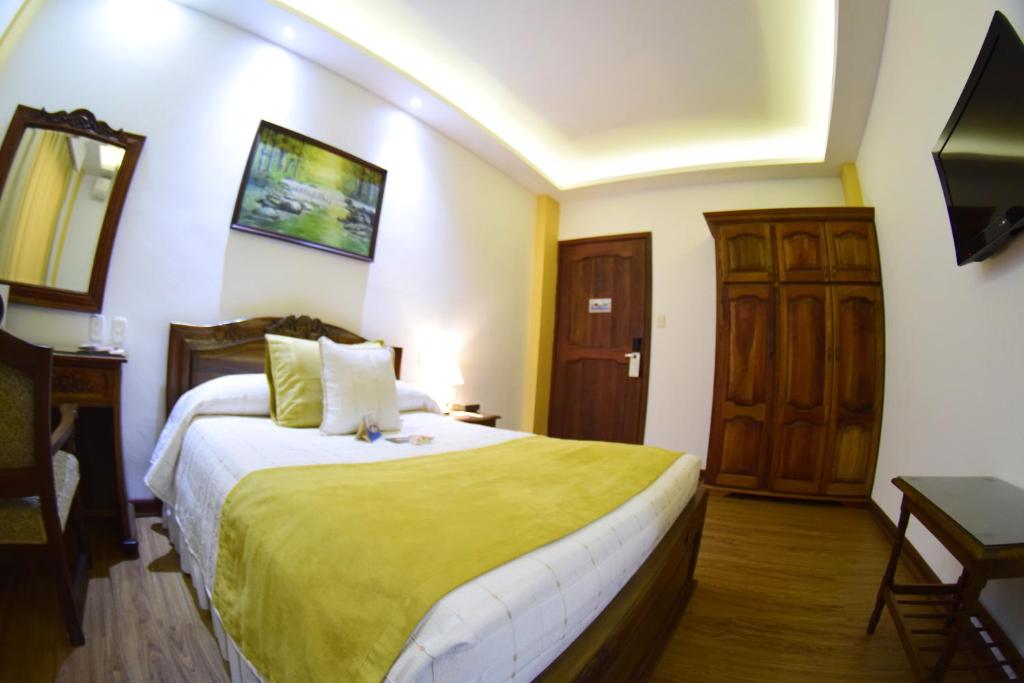 Postel nebo postele na pokoji v ubytování El Gran Hotel de Pereira