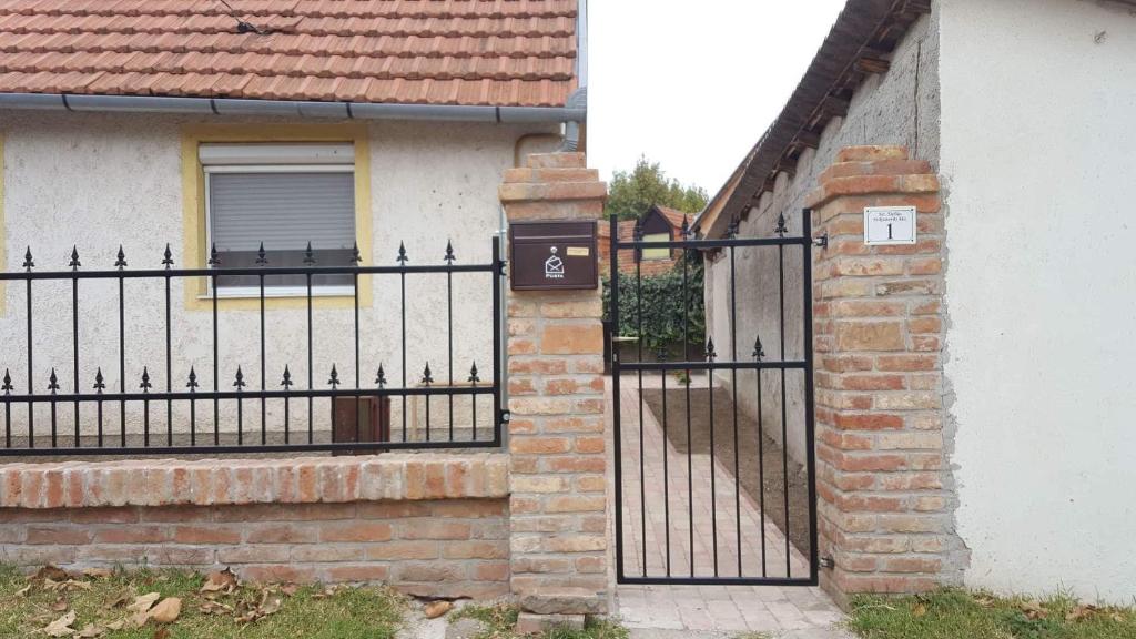 a wrought iron fence in front of a house at Joóreménység Vendégház in Siklós