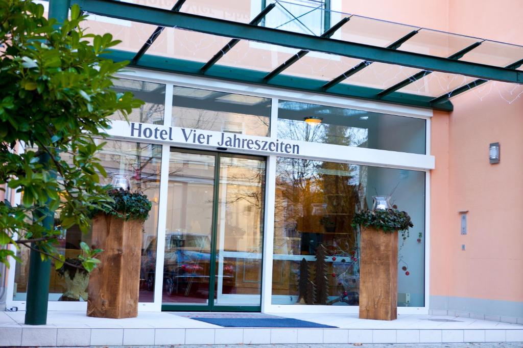 a hotel sign in front of a building at Hotel Vier Jahreszeiten in Bad Reichenhall