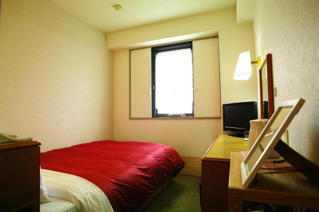Postel nebo postele na pokoji v ubytování Tourist Hotel Hitachi