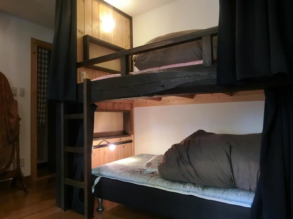 Postel nebo postele na pokoji v ubytování Hakuba Kaze no Ko