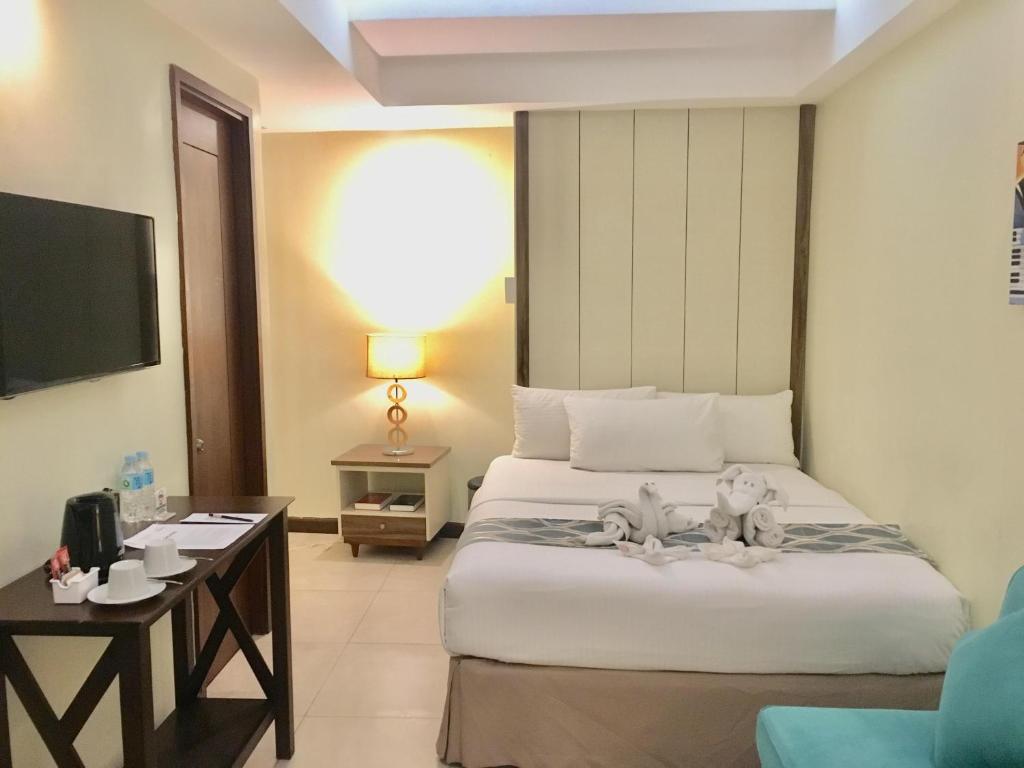 Postel nebo postele na pokoji v ubytování Belian Hotel