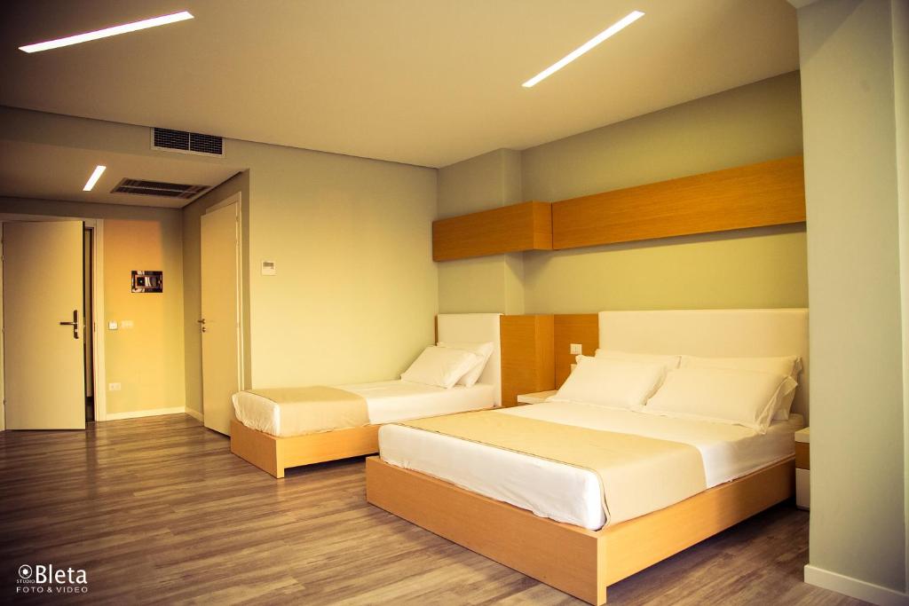 Postel nebo postele na pokoji v ubytování Hotel Bologna