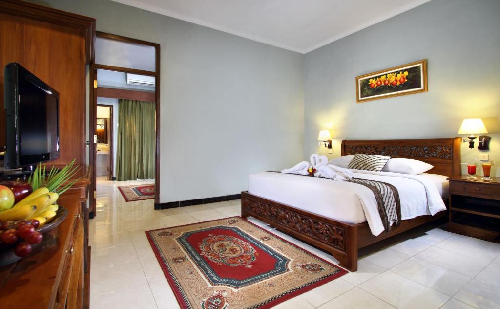 Letto o letti in una camera di Cakra Kusuma Hotel