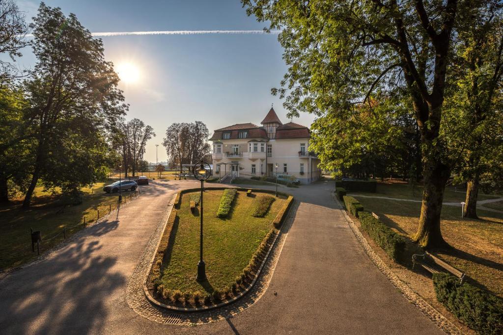 an empty street in front of a white house at Boutique Hotel Korana Srakovcic in Karlovac