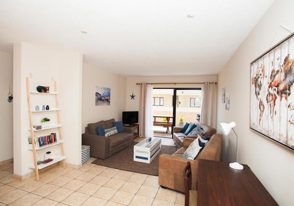 a living room with a couch and a table at Bianka's Self-Catering Apartment in Swakopmund