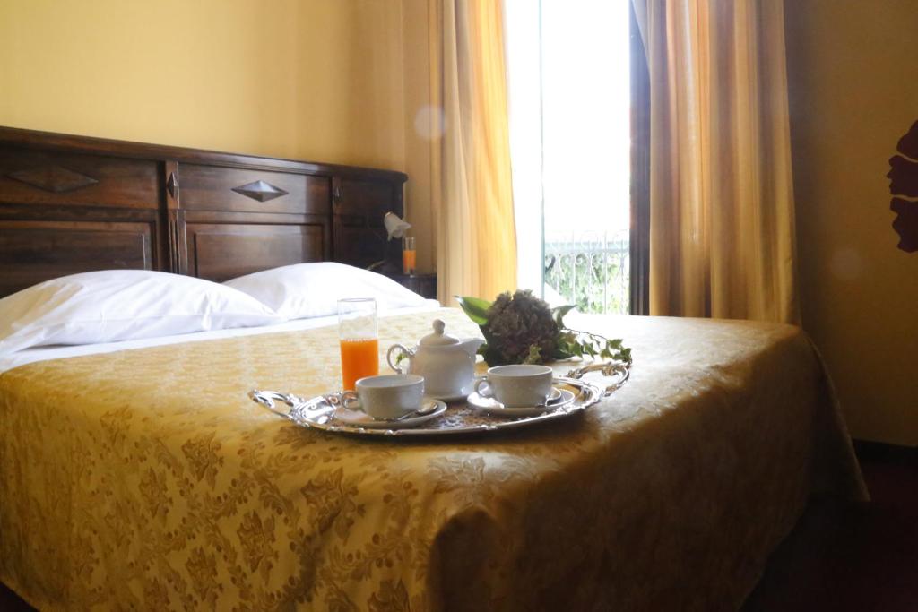 Postel nebo postele na pokoji v ubytování Hotel Damian Park Hotel Delle Magnolie