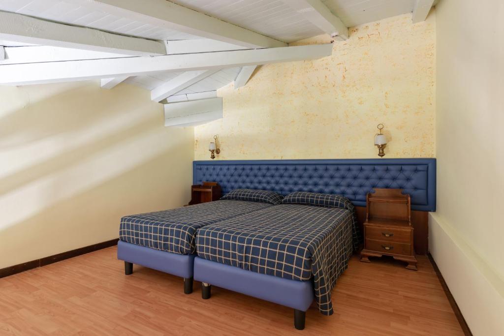 Postel nebo postele na pokoji v ubytování Hotel Malcesine