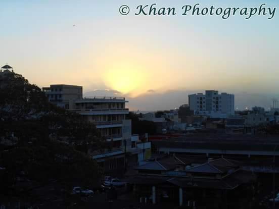 a view of a city with the sunset in the background at La Plaine Verte Guesthouse in Port Louis