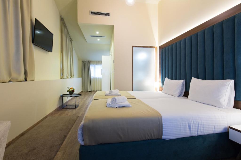 Postel nebo postele na pokoji v ubytování Marquise Hotel Garni