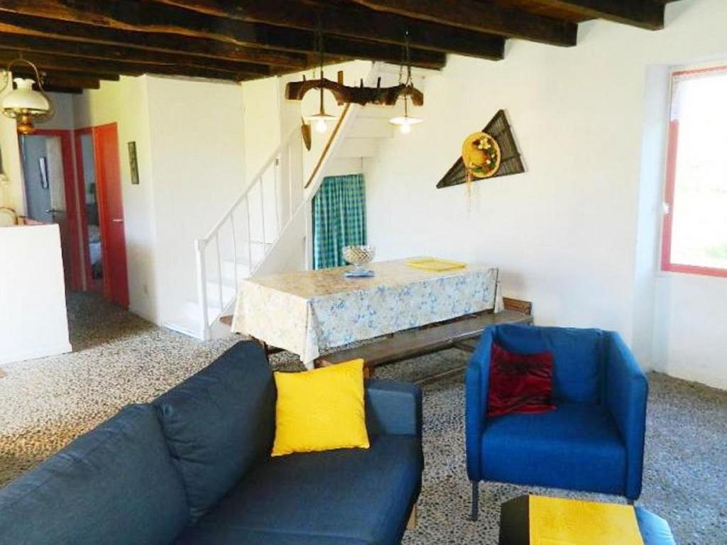 a living room with a couch and a table at Comfortable holiday home with garden in Sainte-Croix-de-Beaumont