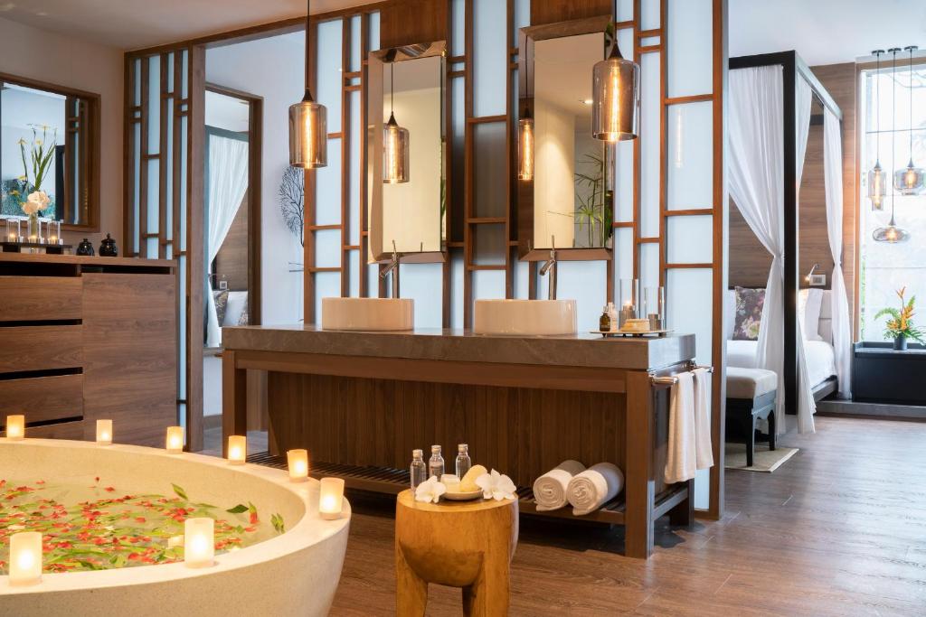 a bathroom with a bath tub in a room at The Sarojin in Khao Lak