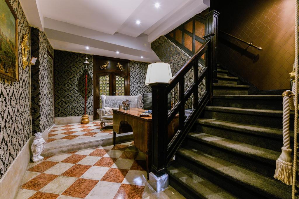 a staircase in a room with a checkered floor at Ai Cherubini in Venice