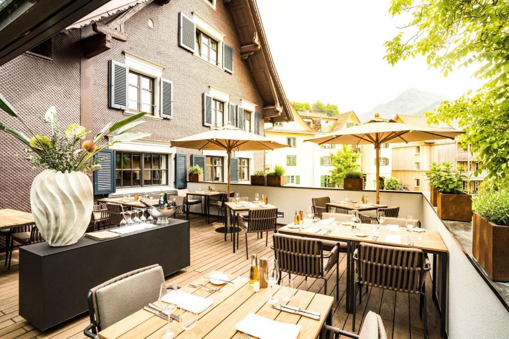 a restaurant with tables and chairs on a patio at Hotel Zum Verwalter Dornbirn in Dornbirn