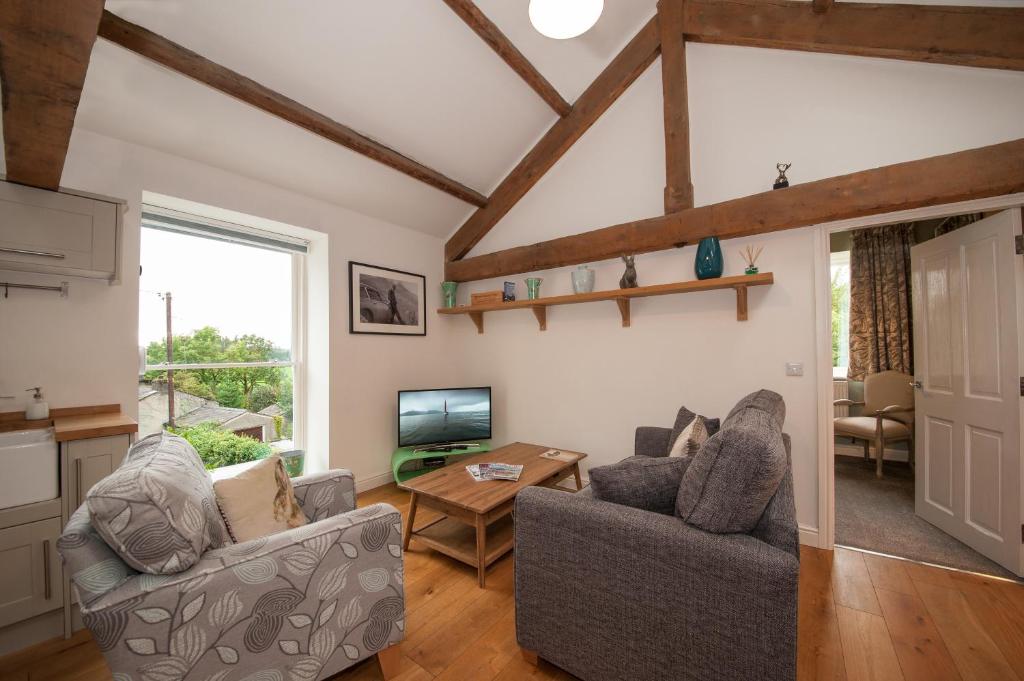 a living room with two couches and a tv at The Hare and Hounds, Levens in Levens