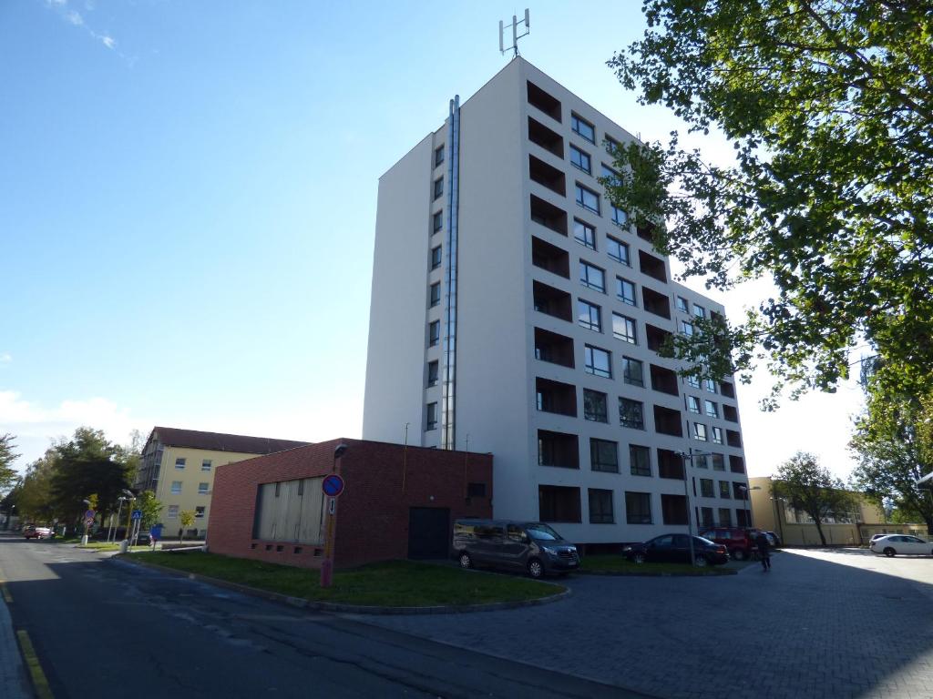 a tall white building on the side of a street at Mountain View Studio Apartment in Poprad