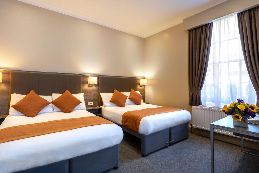 Postel nebo postele na pokoji v ubytování Sidney Hotel London-Victoria