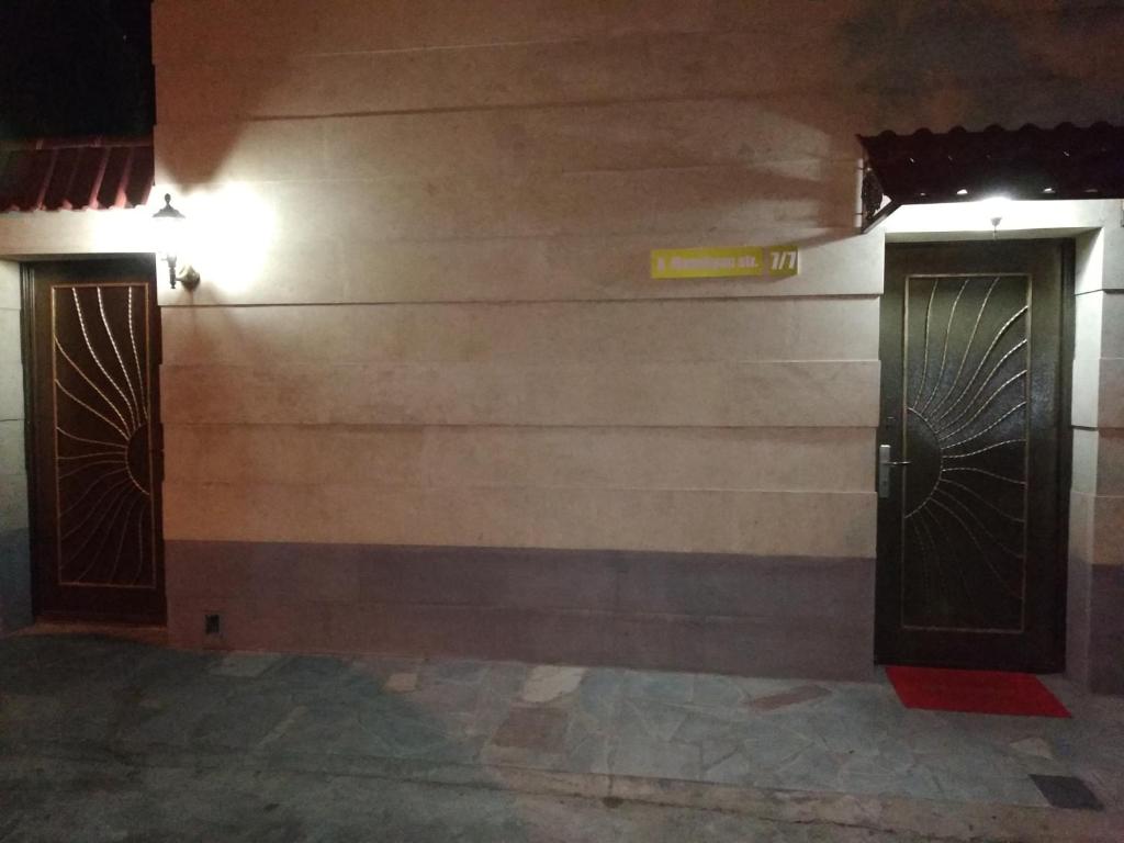 a wall with two doors in a building at Apart hotel Alex in Yerevan