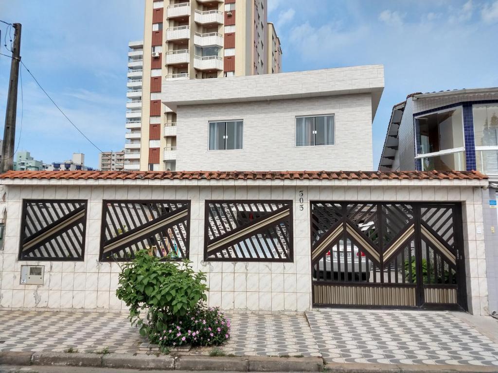 a building with a black and white gate at Pousada do Chileno in Praia Grande