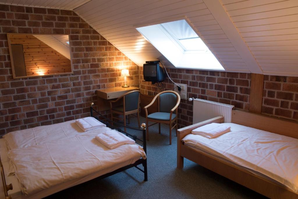 Postel nebo postele na pokoji v ubytování Hotel de Lindeboom