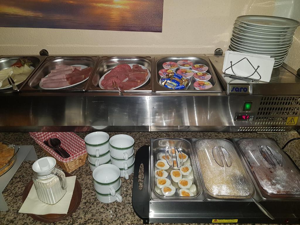 a buffet line with different types of breakfast foods at Pension Kuehnauer Hof in Dessau