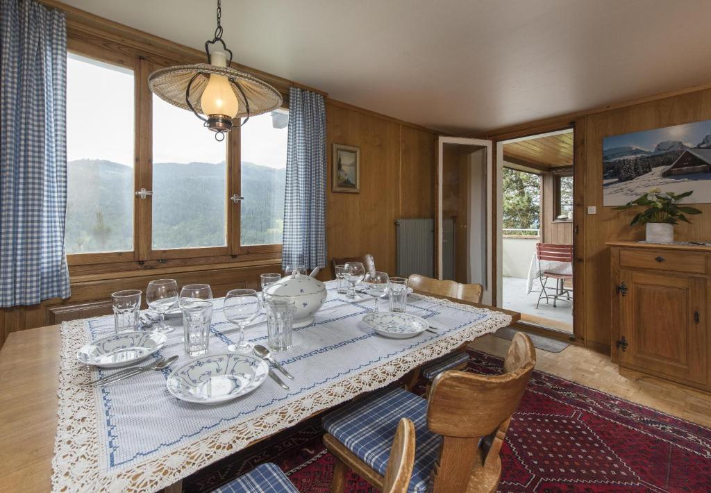 a dining room with a table with glasses on it at Chalet Ritornell in Wildhaus