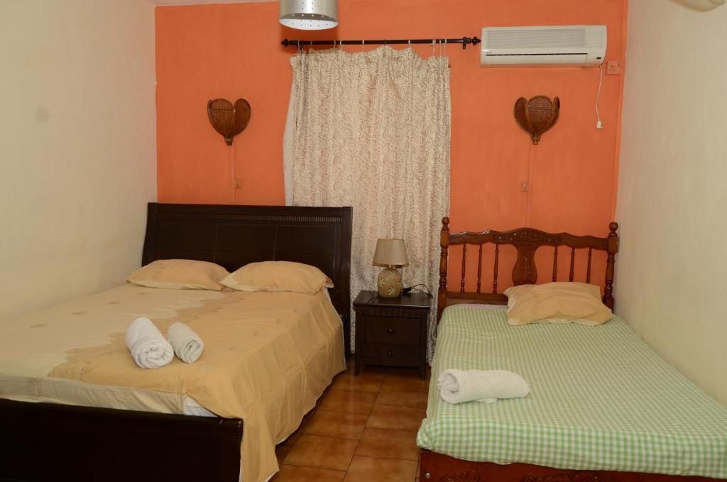 Postel nebo postele na pokoji v ubytování Dookee House