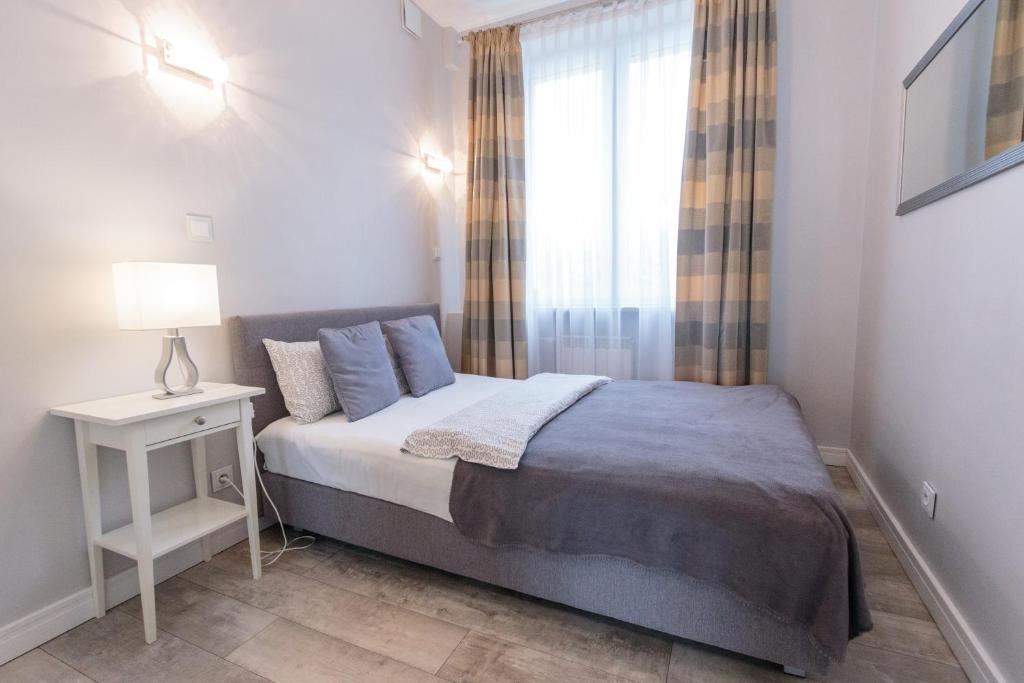 Posteľ alebo postele v izbe v ubytovaní Rental Apartments Krochmalna